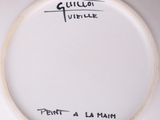 a white plate with black writing on it on a table