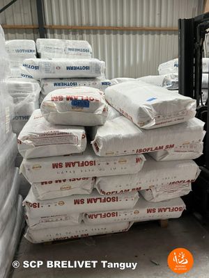 many bags of cement sitting on a pallet in a warehouse