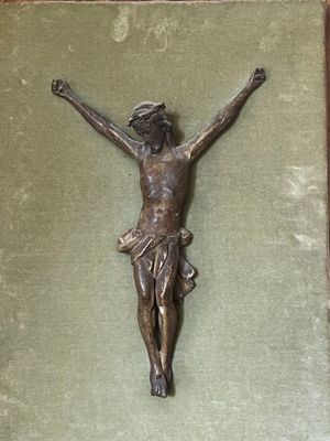 a statue of jesus on the cross on a green cloth