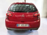 the rear end of a red citrole parked in a garage