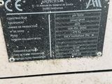 a sign on the side of a machine that is sitting on the ground