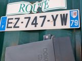 a sign that says route e7 74 yw on the side of a green truck