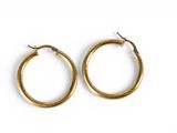 a pair of gold hoop earrings on a white background