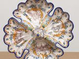 a decorative plate with a blue and yellow flower on it