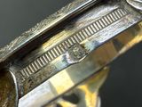 a close up of a silver plate with a knife on it