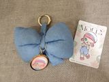 a small blue bow with a picture of a girl on it