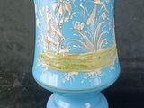 a blue vase with a gold design on it