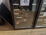 two wine coolers sitting next to each other on the floor