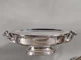 a silver plate that is on a table with a spoon