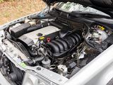 a silver car with its hood open and the engine in it