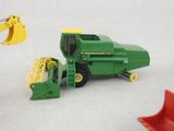 a green toy truck and a red toy bulldozer