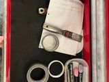 a red box that has some pens and other items in it