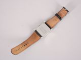 an image of a close up of a wrist watch on a white surface