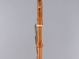 a close up of a bassoon on a clear surface