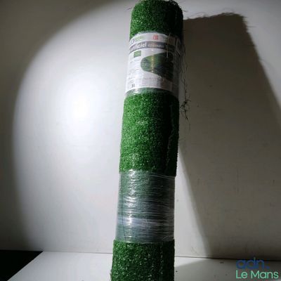 un rouleau de gazon synthétique emballé dans du plastique