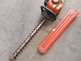 a picture of a hedger and a tool on the ground