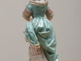 a figurine of a woman sitting on a table