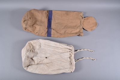 two bags of cloth are sitting on a gray surface