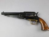 a close up of a revolver on a table with a white background