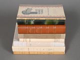 several books are stacked on top of each other on a table