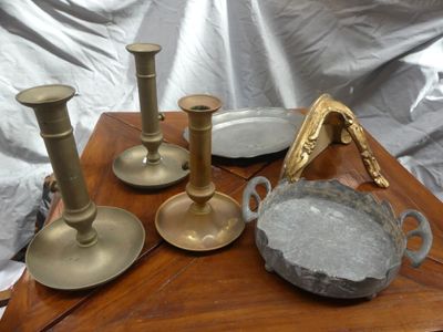 three candles and a bowl on a table