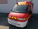 an image of a red and yellow fire truck parked in front of a building