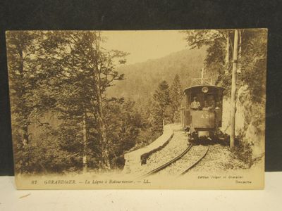 an old photo of a train going down the tracks