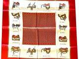 red and white square scarf with a picture of horses and saddles on it
