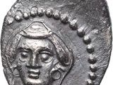 a silver coin with a man ' s face on it