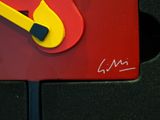 a yellow fire extinguisor on a red sign