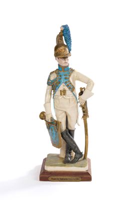 figurine of a man in a uniform with a sword and shield