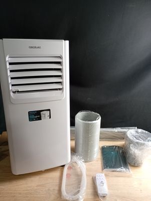 a small air conditioner sitting on a table next to other items