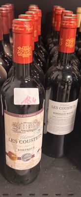 many bottles of wine sitting on a shelf in a store