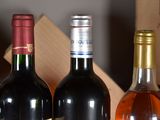 several bottles of wine are lined up in a row on a table