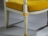 yellow upholstered chair with wooden legs and a yellow upholstered seat