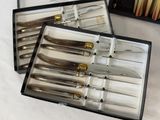 a lot of knives in a box on the table