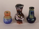 three vases sitting next to each other on a table