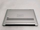 a laptop that is sitting on a white surface