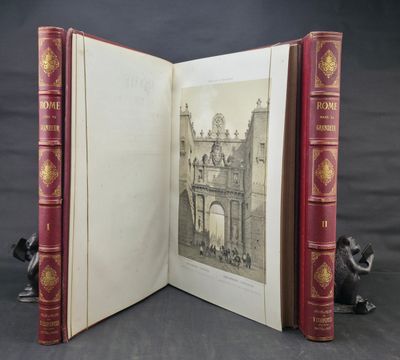 an open book sitting on top of a table next to a figurine