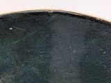 a close up of a black plate with a white background