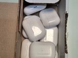 a box of airpods sitting on a table next to a computer mouse