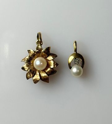 pair of pearl and gold flower earrings on a white surface