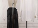 two mannequins in front of a white shirt and black skirt