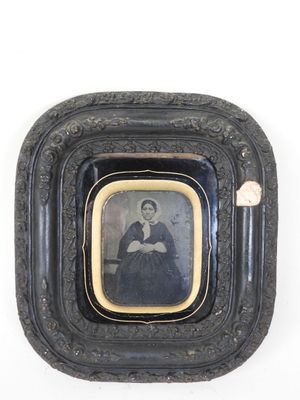 an old black and white photo of a woman in a black dress