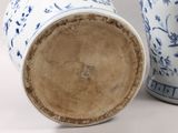 two blue and white vases sitting next to each other