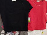 three shirts hanging on a clothes rack in a room