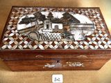 a wooden box with a painting on it sitting on a table