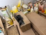 many bags of food sitting on the floor next to boxes