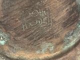 a close up of a metal plate with writing on it