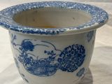 a blue and white vase with a bird design on it